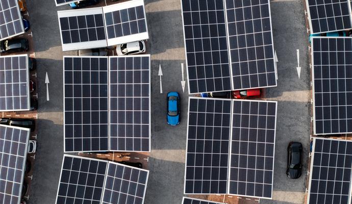 Electric cars at solar-powered charging stations, seen from above