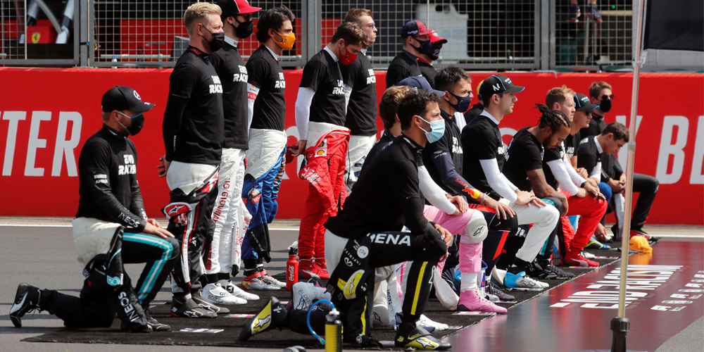 Lewis Hamilton and other drivers kneel in support of the Black Lives Matter campaign before the start of England’s 70th Anniversary Grand Prix, in August 2020. Lewis Hamilton and other drivers kneel in support of the Black Lives Matter campaign before the start of England’s 70th Anniversary Grand Prix, in August 2020.