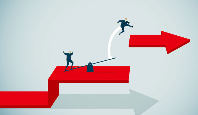 An illustration shows a businessperson catapulting another businessperson over a gap and onto a higher level. An illustration shows a businessperson catapulting another businessperson over a gap and onto a higher level.