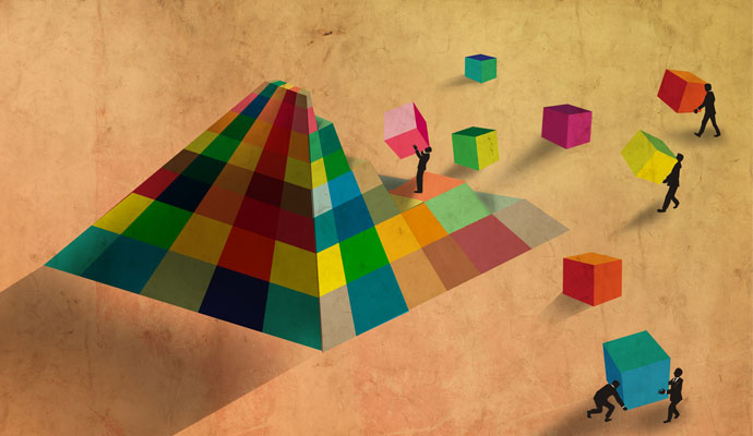 A stylized cartoon shows businesspeople assembling a pyramid with multicolored blocks. A stylized cartoon shows businesspeople assembling a pyramid with multicolored blocks.