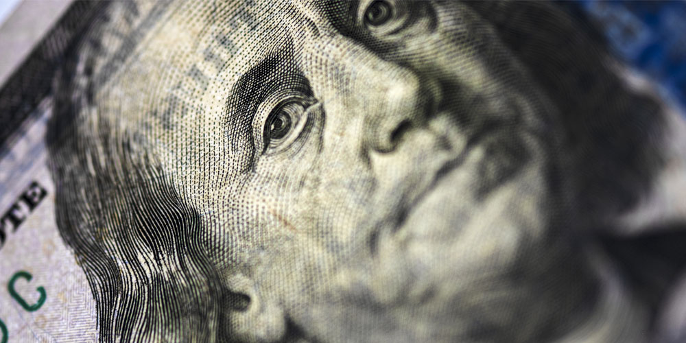 A close-up view of a US$100 bill frames a concerned-looking Benjamin Franklin. A close-up view of a US$100 bill frames a concerned-looking Benjamin Franklin.