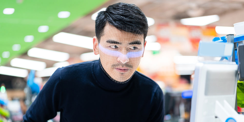 Customer undergoing facial scan at automated store checkout Customer undergoing facial scan at automated store checkout