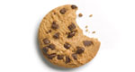 Close-up of a chocolate chip cookie with a bite taken out of it, on a white background.