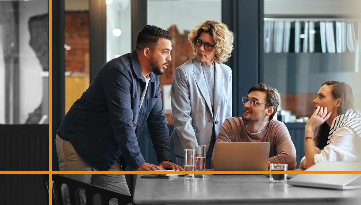 A group of businesspeople meet in an informal setting to discuss work A group of businesspeople meet in an informal setting to discuss work