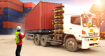 Foreman checks a tractor trailer in a busy container depot