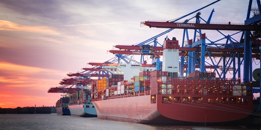 Photo of loaded container ships at a port Photo of loaded container ships at a port