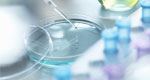 A close-up view of a pipette and a petri dish in a lab.