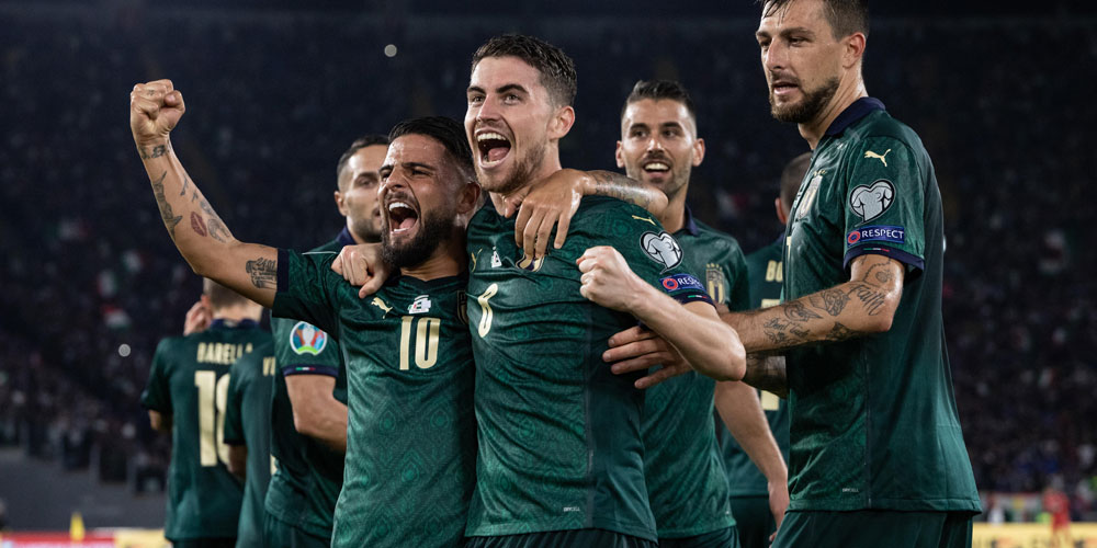 Members of the Italian national soccer team celebrate scoring a goal during a qualifying match for the UEFA European Championship. Members of the Italian national soccer team celebrate scoring a goal during a qualifying match for the UEFA European Championship.