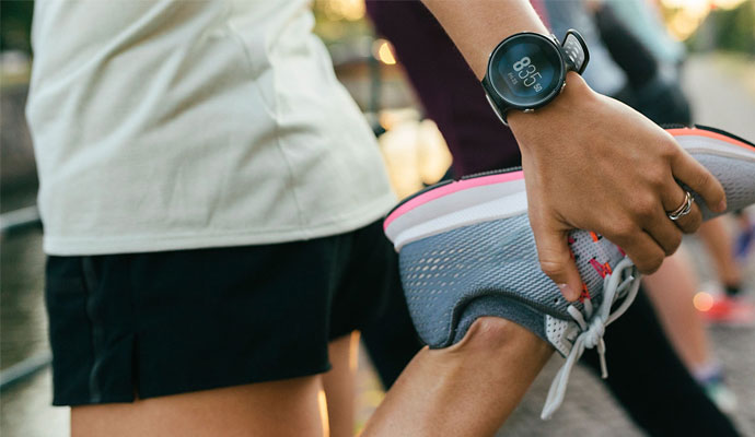 A photograph of a person exercising and wearing a fitness tracking watch.