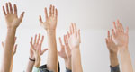 Stock photograph of raised hands