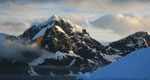 A photo of Elephant Island in Antarctica, against a blue sky with heavy clouds.