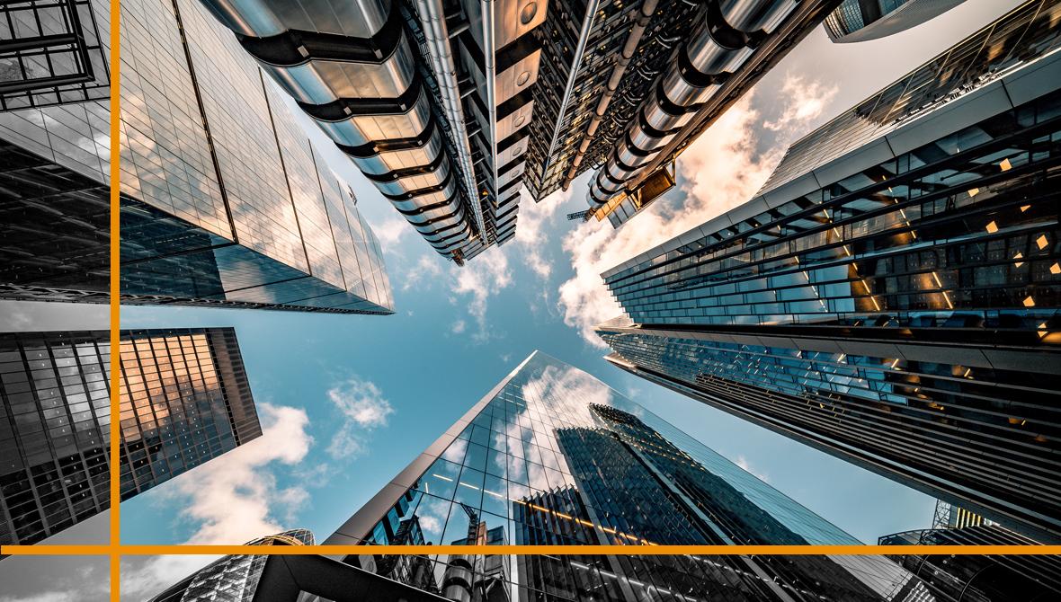 A worm's-eye view of glass-and-steel skyscrapers reflects the blue sky and clouds above A worm's-eye view of glass-and-steel skyscrapers reflects the blue sky and clouds above