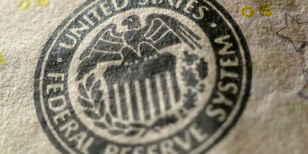 A close-up view of a US$100 bill shows the seal of the US Federal Reserve. A close-up view of a US$100 bill shows the seal of the US Federal Reserve.