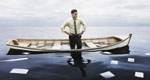 A businessman stands in a sinking boat with oars and papers floating away into an overcast sea
