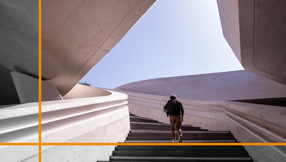 Unrecognised person walking at the stairs leading to a bright open space Unrecognised person walking at the stairs leading to a bright open space
