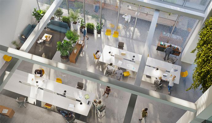 A high-angle perspective shows a modern open-office environment from above, with employees using the space to either work individually or to collaborate in small groups.