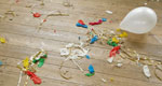 A photograph of popped and deflated balloons after a party.