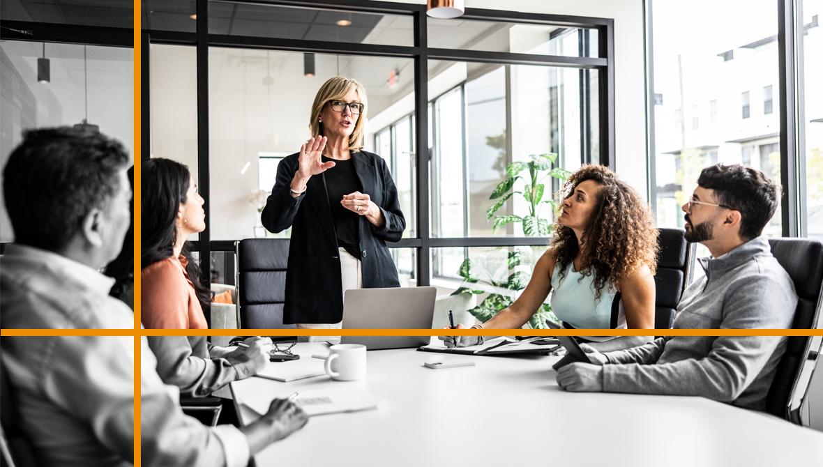 A businesswoman makes a presentation to a small group of colleagues in a conference room. A businesswoman makes a presentation to a small group of colleagues in a conference room.
