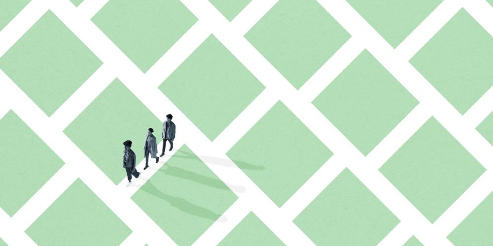Three black-and-white figures walk a grid of white lines amid green squares.