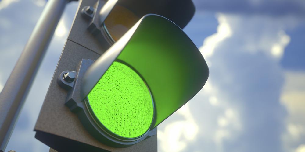 A closeup photograph of a green traffic light A closeup photograph of a green traffic light