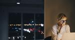 Woman in deep concentration at her desk at night