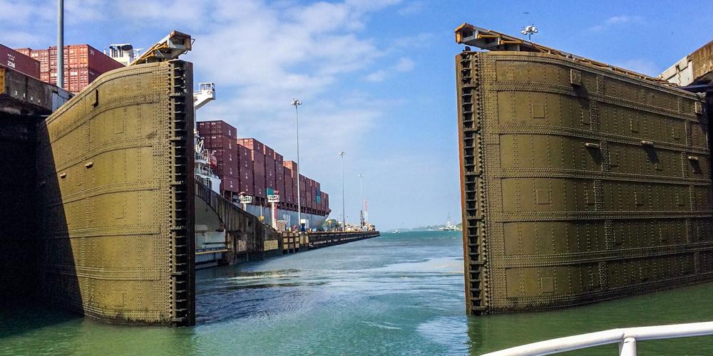 A photograph of a lock gate opening in the Panama Canal A photograph of a lock gate opening in the Panama Canal