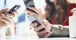 Photograph of the hands of three people holding phones