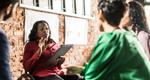Businesswoman in wheelchair leading group discussion in office