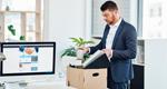 Businessman packing up his desk at work