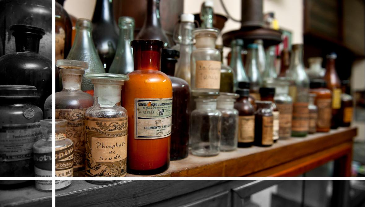 Bottles of pharmacy ingredients sit on a shelf Bottles of pharmacy ingredients sit on a shelf