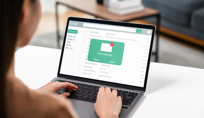 A woman uses a laptop to access email A woman uses a laptop to access email