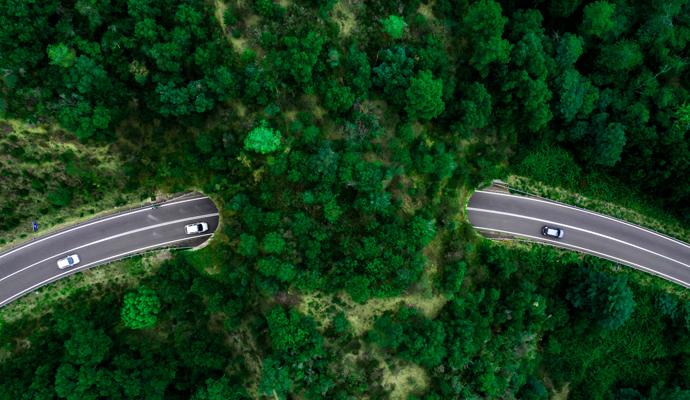 Aerial view of green bridge over a highway, which allows wildlife to cross safely