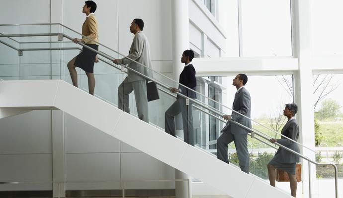 Group of business people climbing stairs