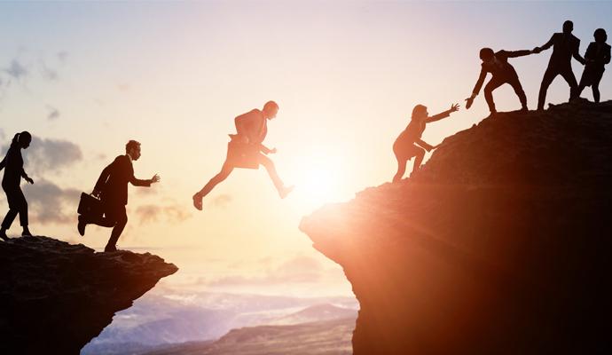 A group of businesspeople climbing a mountain