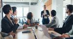 A business leader addressing her team in a meeting
