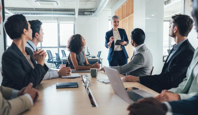 A business leader addressing her team in a meeting