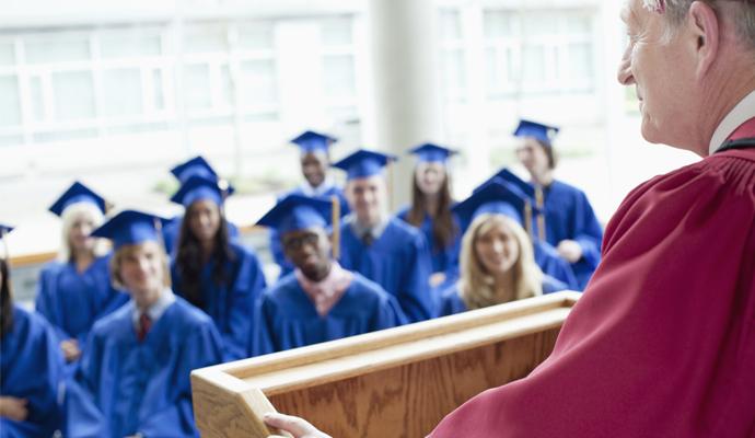 Graduates listening to key speaker at graduation ceremony