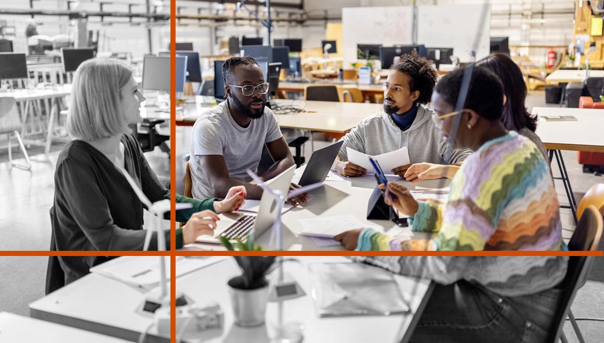 Five colleagues sit at a table in a casual open-office environment for a planning session.