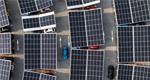 Electric cars at solar-powered charging stations, seen from above