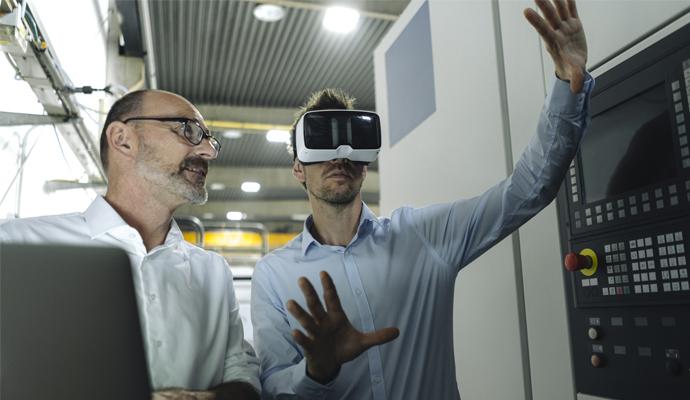 Two men with VR glasses in factory