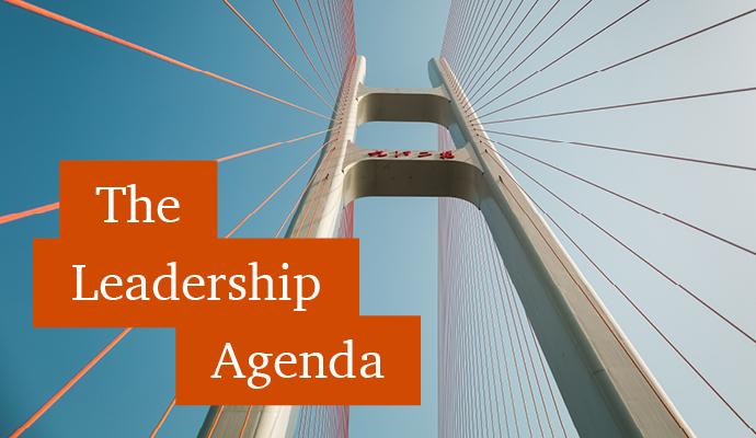 Photograph of a top of a suspension bridge tower with the words "The Leadership Agenda" superimposed