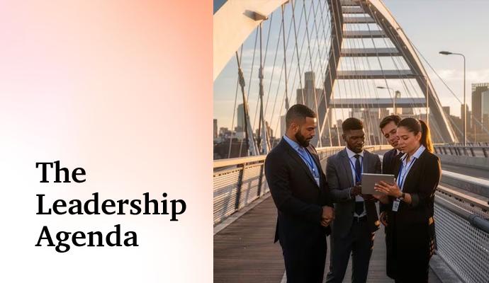 “Business colleagues gathered outdoors on a pedestrian bridge, reviewing information on a tablet.