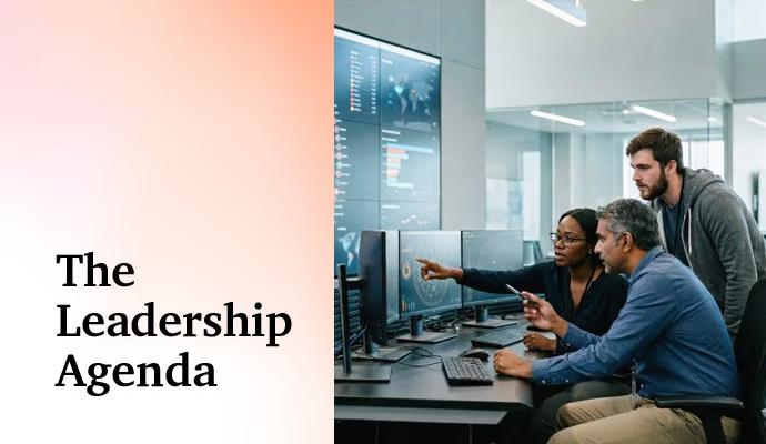 Team reviewing charts and information on computer screens in a modern office.