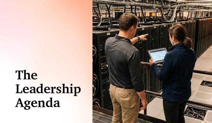 Two colleagues in a data center review information on a tablet as one gestures toward the servers. Two colleagues in a data center review information on a tablet as one gestures toward the servers.