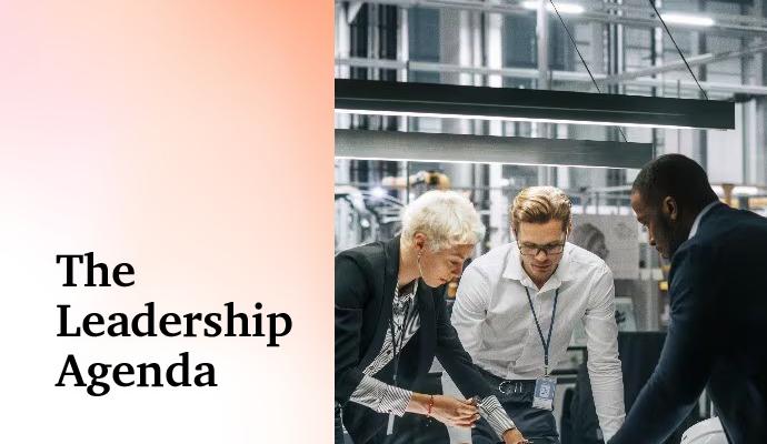 Photograph of three coworkers standing around a table  with the words "The Leadership Agenda" superimposed