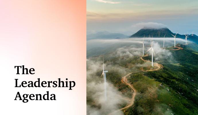 Wind turbines lining a mountain ridge, generating renewable energy above the clouds.