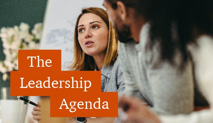 A photograph of a woman chatting with co-workers in an office setting with the words "The Leadership Agenda" superimposed