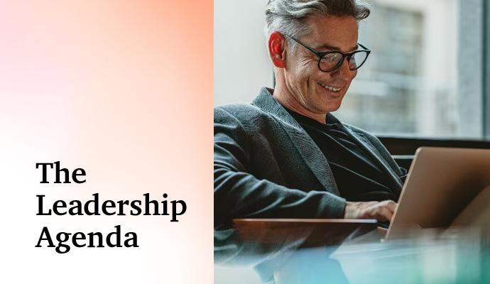 A man sitting with a laptop in his lap with the words "The Leadership Agenda" superimposed