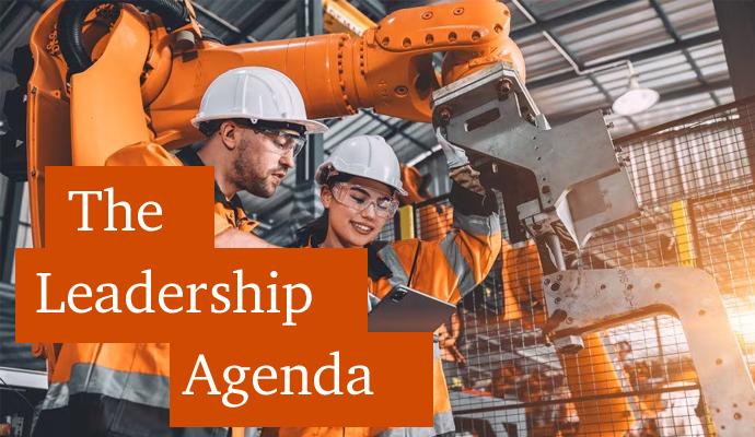 Photograph of two workers in a factory with the words "The Leadership Agenda" superimposed