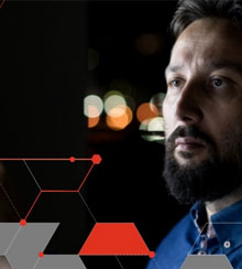 A photograph of a man looking into the distance.